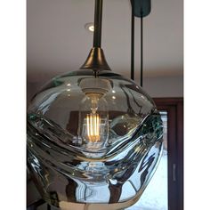 a glass light fixture hanging from the ceiling