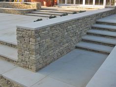 a stone wall with steps leading up to it