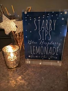 there is a sign that says starr sips and lemonade next to some candles