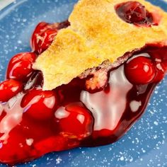 a piece of cherry pie on a blue plate