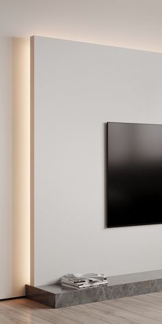 a flat screen tv mounted to the side of a wall in an empty living room