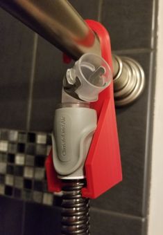 a red and white gas pump attached to a tiled wall