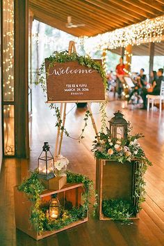 a wooden sign with greenery on it that says welcome to the newly married couple