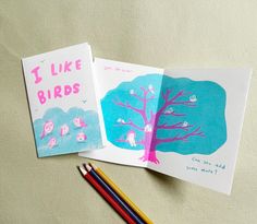 two children's books with pencils on top of them and an image of a tree that says i like birds