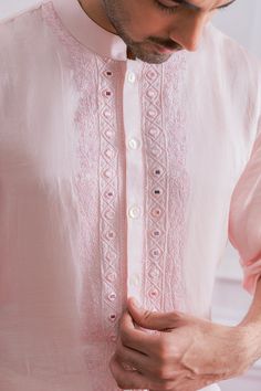 Editor's Note Featuring A Bespoke Powder Pink Nehru Jacket With Intricate Hand Embroidery, Metal Buttons And Minimal Detalis. Perfect For Any Indoor Or Outdoor Occasion. This Comes With A Tonal Plain Powder Pink Satin Linen Kurta And Ivory Churidaar. Color: Pink Fabric: Cotton & Silk Care: Dry Clean Only About the Designer Ankit V Kapoor is a clothing brand that amalgamates traditional Indian handicrafts and bespoke tailoring. Inspired by the heritage of India and unified with revolutionary thou Light Pink Kurta For Men, Gents Kurta Embroidery Design, Mirror Work Kurta For Men, Sikh Groom, Powder Pink Color, Baby Pink Wedding, Modern Groom