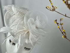 Discover the quintessence of elegance with our exquisite white fascinator hat, a must-have for any fashion-forward socialite. This impeccable headpiece is designed to turn heads at any high-class event, from the thunderous cheer of the Derby to the serene ambiance of Sunday service at church. The luxurious high-tech spandex material gives the fascinator a sophisticated sheen, providing a delicate blend of modern craftsmanship and timeless style. Imagine yourself at the centerpiece of a regal wedding or exuding grace at an upscale tea party; our versatile fascinator is the perfect complement to your chosen attire, equally suited for a grand royal event or a tasteful cocktail soirée. The hat's detailed floral arrangement and fluttering feathers are meticulously crafted, ensuring that your pr White Fascinator, Sunday Service, Fascinator Hat, Fascinator Hats, Timeless Accessories, Modern Chic, Social Events, High Class, Kentucky Derby