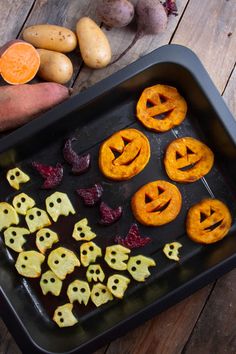 halloween treats are arranged on a baking sheet with jack - o'- lantern faces