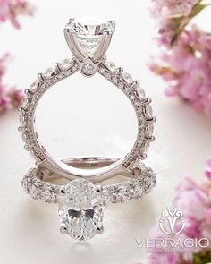 a close up view of a diamond ring with pink flowers in the background and text overlay that reads, verragio