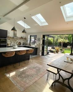 an open kitchen and dining room with skylights