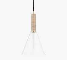 a glass and wood pendant light hanging from a ceiling fixture with a black cord attached to it