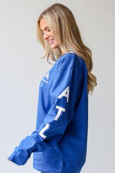 Calling all Braves fans, the Royal Blue Atlanta Baseball Pullover was made just for you! This comfy sweatshirt is designed with a soft and stretchy knit with a fleece interior. It features a crew neckline, long sleeves with "ATL", a relaxed fit, and the words "Atlanta Baseball" on the front. Style the Royal Blue Atlanta Baseball Pullover with your favorite denim and a baseball hat for a game day look! Soft + Stretchy Knit Fabrication Fleece Interior "Blue Atlanta Baseball" Graphic Crew Neckline Black Sunglasses Square, Dresses Royal, Exclusive Dress, Royal Blue Dresses, Royal Blue Color, Comfy Sweatshirt, Black Square, White Midi Dress, Heart Earrings Studs