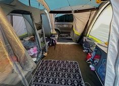 the inside of a camper with several tents set up in it's back