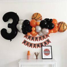 a birthday decoration with balloons and basketballs