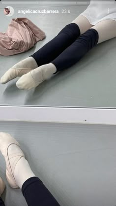 a person laying on the ground with their legs up and feet down, both wearing white socks