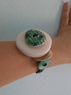 Button bracelet is made on a strong wax cotton thread which is made up of 18 buttons. Bracelet is in green,beige and black color. The length of the bracelet is 18cm. Smaller buttons is 9 mm and bigger is 45 mm.  Here you can see more button jewelry: https://www.etsy.com/shop/StAnaDugme Handmade Wearable Art Green Bracelets, Handmade Green Wearable Art Bracelet, Ceramic Buttons, Womens Bracelet, Button Bracelet, Butterfly Pin, Button Jewelry, Button Crafts, Waxed Cotton