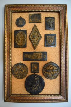 there are many different types of decorative items on this wall hanging in a frame with gold trim