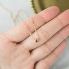 "14k solid rose gold dahlia setting floating ruby necklace. This setting is my signature style using milgrain frame to add a bit of antique taste to the simple and subtle necklace. It is so lightweight, perfect everyday piece. This ruby has a lot of sparkles and with a deep wine red hue. Purchase this beautifully handcrafted necklace for special occasions such as birthdays, anniversaries, holidays, Mother's Day, Valentine's Day, or even for bridesmaids! * Sold as one necklace * Setting size: 2mm Dainty Ruby Gemstone Birthstone Necklace, Dainty Ruby Birthstone Necklace, Delicate Rose Gold Round Pendant Birthstone Necklace, Minimalist Ruby Birthstone Necklace, Rose Gold Ruby Birthstone Necklace, Dainty Ruby Jewelry With Bezel Setting, Ruby Necklace With Bezel Setting As Gift, Red Ruby Necklace With Bezel Setting, Dainty Rose Gold Birthstone Necklace With Round Pendant