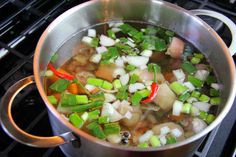 a pot filled with food sitting on top of a stove