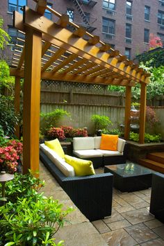 an outdoor living area with couches and tables