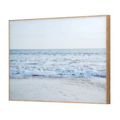 an ocean scene with waves crashing on the beach and sky in the background framed canvas wall art print