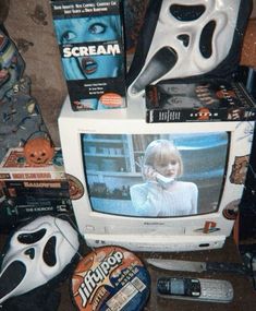 there are many items on the table including a television, mask, and remote control