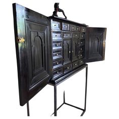 an old black cabinet with many drawers on it