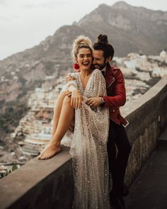 a man and woman sitting on top of a wall next to each other with the caption instagram