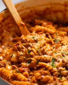 a pot filled with pasta and meat sauce