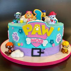 a birthday cake decorated with cartoon characters on it