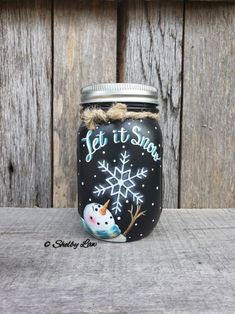 a mason jar with a snowflake design on the lid and let it snow