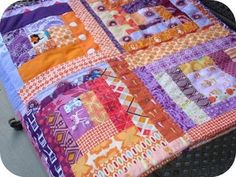 a colorful quilt is laying on top of a chair