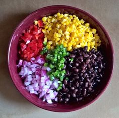 a bowl filled with lots of different types of beans and corn on top of each other