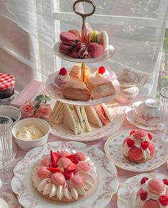 a table topped with plates and cakes covered in frosting