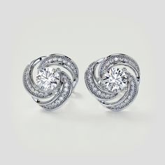 Show your love for all the finer things with this dazzling set of earrings. Featuring an astonishing wave like design, all completed with our beaming simulated diamonds caressed within elegant beaded milgrain detail. A divine set to dress up any occasion.  Round Cut Swirl Halo Earrings Center Stone: .75CT Each Total Carat Weight: 1.81CTW Stone Clarity: VVS-1 Available in:925 Sterling Silver Model: ER2493-WH-SL Tiffany Engagement Ring, Halo Diamond Earrings, Halo Earrings, Gold Models, Halo Pendant, Lab Grown Diamonds Engagement, Free Earrings, Halo Engagement Rings, Solitaire Pendant