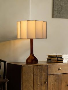 a table lamp sitting on top of a wooden dresser