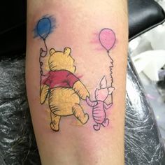 a winnie the pooh tattoo with balloons