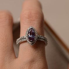 Alexandrite engagement ring marquise cut halo ring June | Etsy Marquise Cubic Zirconia Halo Ring, 14k White Gold Marquise Rings, Silver Marquise Birthstone Ring For Anniversary, 14k White Gold Marquise Cut Halo Jewelry, White Gold Marquise Halo Jewelry, Marquise Halo White Gold Jewelry, Silver Marquise 14k White Gold Wedding Ring, Silver Marquise Cut Halo Wedding Ring, Purple Marquise Diamond Jewelry