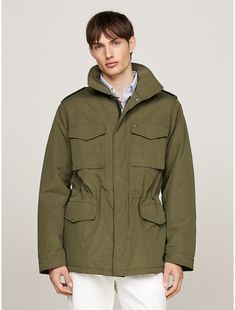 Tommy Hilfiger men's jacket. This field jacket features a detachable hood and multiple pockets on the front for practicality, as well as an authentic utility-informed aesthetic.  Material: 100% Polyamide. Functional Khaki Outerwear With Multiple Pockets, Functional Khaki Parka With Pockets, Olive Utility Outerwear With Patch Pockets, Functional Khaki Outerwear With Pockets, Military Style Outerwear With Multiple Pockets For Outdoor Activities, Military Style Outerwear With Multiple Pockets For Outdoor, Winter Cargo Pocket Utility Jacket In Khaki, Military Outerwear With Multiple Pockets For Outdoor Activities, Utility Parka With Multiple Pockets For Outdoor