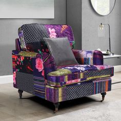 a colorful chair with pillows on it in a room