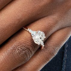 a woman's hand with a diamond ring on it