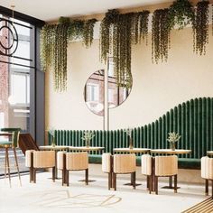 an empty restaurant with tables, chairs and plants hanging from the wall in front of it