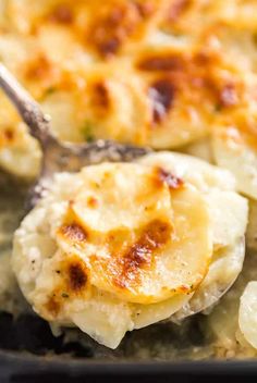 a close up of food on a spoon in a pan with broccoli and potatoes