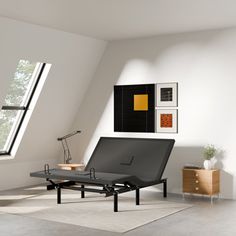 an empty living room with a black chaise lounger