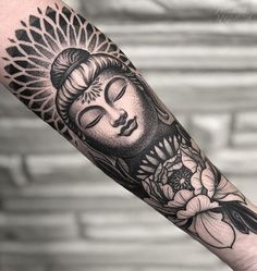 a buddha tattoo on the arm