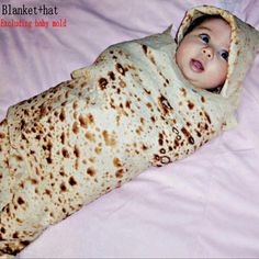 a baby wrapped in a blanket laying on top of a pink bed sheet with the words blanket that exclucing baby hold