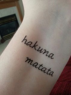 a woman's arm with the words hakuna matata written on it