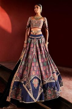 This chic dark blue jamawar lehenga set is an exquisite embodiment of timeless elegance. The square neckline blouse features intricate hand-embroidered zari work, complemented by delicate pearls and geometric latkans, seamlessly blending tradition with modern flair. The flowing jamawar skirt showcases stunning embroidered appliqué and vibrant bead details, while the opulent zari border adds a touch of grandeur. Finished with a meticulously handcrafted belt to define the waist, this luxurious masterpiece is perfect for those who cherish the finer things in life, making it an impeccable choice for any grand occasion. Elegant Meenakari Lehenga, Elegant Fitted Meenakari Choli, Elegant Raw Silk Choli With Motifs, Elegant Semi-stitched Lehenga With Meenakari Details, Elegant Fitted Lehenga With Meenakari Detailing, Elegant Meenakari Lehenga In Traditional Drape, Elegant Meenakari Lehenga With Traditional Drape, Elegant Blue Lehenga With Motifs, Elegant Lehenga With Motifs For Navratri