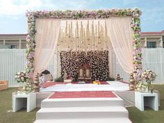 a mandap decorated with flowers and candles