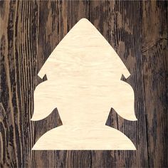 a wood cutout of a rocket ship on a wooden background with text that reads,