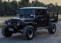 a black jeep parked on the side of a road